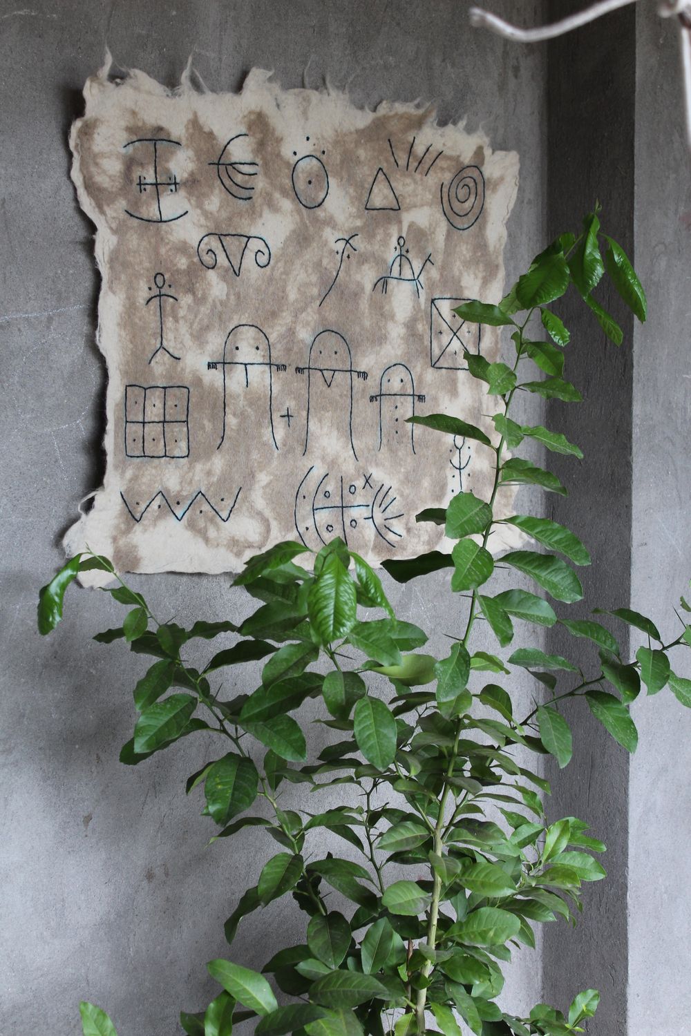 Close view of hand-drawn pictograms on natural felt
